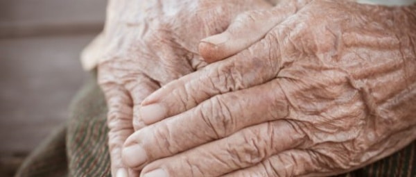112936 hands asian elderly woman grasps her hand lap pair elderly wrinkled hands prayer4236 7441 620x264 1